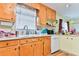 Kitchen with wood cabinets, white appliances, and ample counter space at 3657 Highway 472, Conway, SC 29526