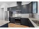 Modern kitchen with dark cabinetry, stainless steel appliances and granite countertops at 403 Mikita Dr., Surfside Beach, SC 29575