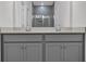 Modern bathroom featuring double vanity with gray cabinets, light countertops, and a tiled walk-in shower at 409 Sun Colony Blvd., Longs, SC 29568