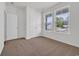 Bedroom featuring carpet, a closet, and two windows providing natural light and street views at 409 Sun Colony Blvd., Longs, SC 29568