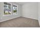 Cozy bedroom with neutral carpet and two large windows, offering street views at 409 Sun Colony Blvd., Longs, SC 29568