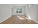 Bright, empty bedroom featuring wood-look floors and natural light from the windows at 409 Sun Colony Blvd., Longs, SC 29568