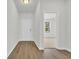 Hallway with hardwood flooring leads to a bedroom; natural light, bright and airy at 409 Sun Colony Blvd., Longs, SC 29568