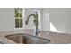 Close up of the kitchen's stainless steel sink and granite countertops at 409 Sun Colony Blvd., Longs, SC 29568