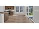 Bright eat-in kitchen featuring stainless appliances, wood cabinets, granite countertops and sliding glass doors to outside at 409 Sun Colony Blvd., Longs, SC 29568