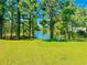 Wooded lot offering a tranquil lake view; build your dream home at 4090 Lake Shore Dr., Little River, SC 29566