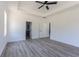 Bright main bedroom with wood-look floors, ceiling fan, and access to bathroom at 4090 Lake Shore Dr., Little River, SC 29566