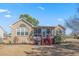 Brick house with a screened porch and deck overlooking a pond at 4110 Fairway Dr., Little River, SC 29566