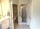 The water closet opens to a full bath featuring a walk-in shower, sink, and ample storage in a neutral color palette at 414 Grand Cypress Way, Murrells Inlet, SC 29576