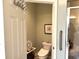 The water closet features neutral decor, a modern toilet, and accessibility features for comfort and convenience at 414 Grand Cypress Way, Murrells Inlet, SC 29576