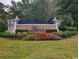 Entrance sign for Seasons at Prince Creek West, adorned with flowers and landscaping, creating a welcoming entry at 414 Grand Cypress Way, Murrells Inlet, SC 29576