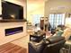 Open-concept living room with a modern electric fireplace and comfortable seating, offering a relaxed atmosphere at 414 Grand Cypress Way, Murrells Inlet, SC 29576