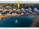 Aerial view showcasing a pond-front home and a community with well-manicured lawns and picturesque water features at 440 Craigflower Ct., Longs, SC 29568