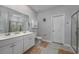 Bathroom featuring double sink vanity, walk-in shower, and tile flooring at 440 Craigflower Ct., Longs, SC 29568