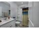 Well-lit bathroom features a vanity with sink and a shower with a shower curtain at 440 Craigflower Ct., Longs, SC 29568
