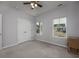 Neutral bedroom with double windows, a ceiling fan, and a double closet at 440 Craigflower Ct., Longs, SC 29568