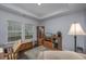 Brightly lit bedroom with dark floors, a comfortable chair, and a display case at 440 Craigflower Ct., Longs, SC 29568