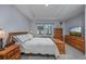 Cozy main bedroom with tray ceilings, carpet, and coordinating wood furniture at 440 Craigflower Ct., Longs, SC 29568