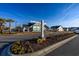 Entrance to Queens Park with beautifully landscaped sign and surrounding homes, creating a welcoming atmosphere at 440 Craigflower Ct., Longs, SC 29568