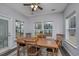 Bright dining area with wood table and chairs, adjacent to a sliding glass door at 440 Craigflower Ct., Longs, SC 29568