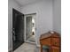 Entryway featuring a wooden antique table, a rug, and a view of the outdoors through the doorway at 440 Craigflower Ct., Longs, SC 29568