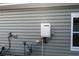 Exterior view of the home featuring a modern tankless hot water heater and a natural gas meter at 440 Craigflower Ct., Longs, SC 29568