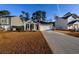 Charming one-story home featuring a two-car garage, long driveway, covered porch, and well-manicured front lawn at 440 Craigflower Ct., Longs, SC 29568