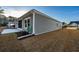 Gray siding house exterior with a partially visible patio and landscaping at 440 Craigflower Ct., Longs, SC 29568