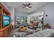 Open concept living room featuring hardwood floors, ceiling fan, and kitchen access at 440 Craigflower Ct., Longs, SC 29568