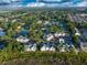 Aerial view showcasing condos, a golf course, and ponds amid lush greenery in a coastal community at 4459 Turtle Ln. # 3D, Little River, SC 29566