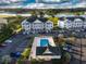 Aerial view of condo building with a pool, cabana, landscaped grounds, and waterway in the background at 4459 Turtle Ln. # 3D, Little River, SC 29566