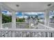 View from covered porch looking at condo buildings, parking lot, and trees at 4459 Turtle Ln. # 3D, Little River, SC 29566