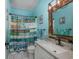 A pretty bathroom is decorated in a sea theme with blue walls and printed curtain at 4459 Turtle Ln. # 3D, Little River, SC 29566