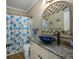 Stylish bathroom with granite countertop, vessel sink, decorative mirror, and shower with patterned curtain at 4459 Turtle Ln. # 3D, Little River, SC 29566