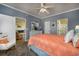 A blue bedroom features an coral bed set and has open doors to a bathroom and living room at 4459 Turtle Ln. # 3D, Little River, SC 29566
