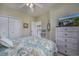 Comfortable bedroom with coastal decor, TV, ceiling fan, and view into the hallway and kitchen at 4459 Turtle Ln. # 3D, Little River, SC 29566
