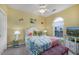 Bright bedroom with large window, TV, ceiling fan, and colorful nautical-themed decor at 4459 Turtle Ln. # 3D, Little River, SC 29566