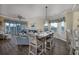 Open dining area with seating for six, adjacent to living area with large windows and natural light at 4459 Turtle Ln. # 3D, Little River, SC 29566