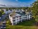 Low angle shows three story condo building with golf course, lake and trees behind it at 4459 Turtle Ln. # 3D, Little River, SC 29566