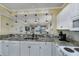 Bright kitchen with granite countertops and white cabinets, open to the dining area and living room at 4459 Turtle Ln. # 3D, Little River, SC 29566