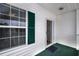 Exterior view of enclosed, covered porch with a full window and half window glass door at 4459 Turtle Ln. # 3D, Little River, SC 29566