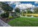 A neighborhood entrance is bordered by a pond, lawn, and various green and flowering plants at 4459 Turtle Ln. # 3D, Little River, SC 29566