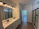 Bright bathroom with double vanity, granite counters, and a glass-enclosed shower at 456 Sun Colony Blvd., Longs, SC 29568