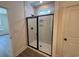 Modern shower with glass door, neutral tile, and sleek shower head fixture at 456 Sun Colony Blvd., Longs, SC 29568