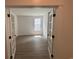Cozy bedroom with hardwood floors, large window, and French doors at 456 Sun Colony Blvd., Longs, SC 29568