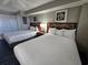 Two double beds, television, and nightstands in a well-lit room at 5300 N Ocean Blvd. # 1005, Myrtle Beach, SC 29577
