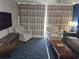 Living room with two striped armchairs, a sofa and a coffee table at 5300 N Ocean Blvd. # 1005, Myrtle Beach, SC 29577