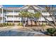 Two-story condo building with balconies and palm trees at 5825 Catalina Dr. # 332, North Myrtle Beach, SC 29582