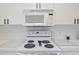 White kitchen appliances including a microwave and electric cooktop at 5825 Catalina Dr. # 332, North Myrtle Beach, SC 29582