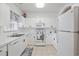 Clean white kitchen featuring sleek countertops, stainless steel sink, and modern appliances at 5825 Catalina Dr. # 332, North Myrtle Beach, SC 29582